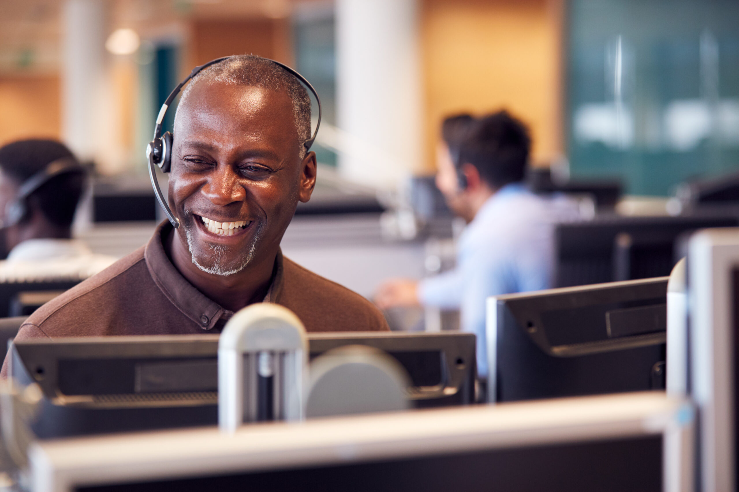 A man wearing a headset smiling