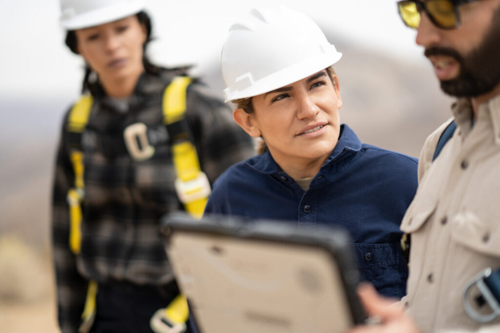 Field engineers discussing data after the inspection of turbines on a wind farm.