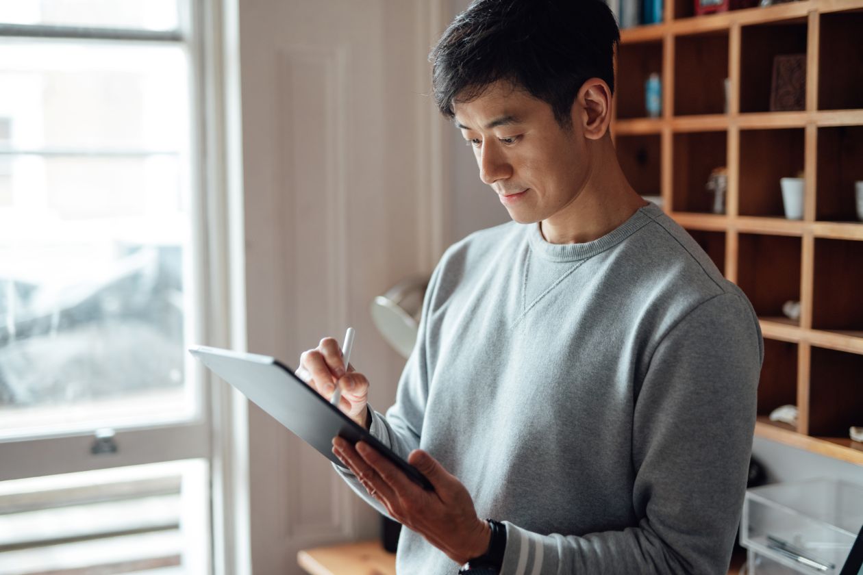 Man operating AI agent on tablet.